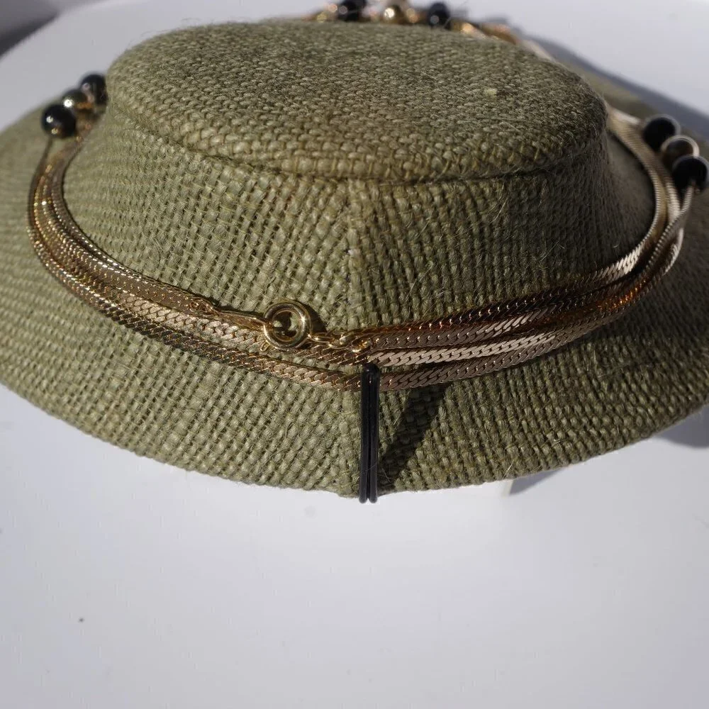 Women`s gold tone black/gold bead chain necklace.
